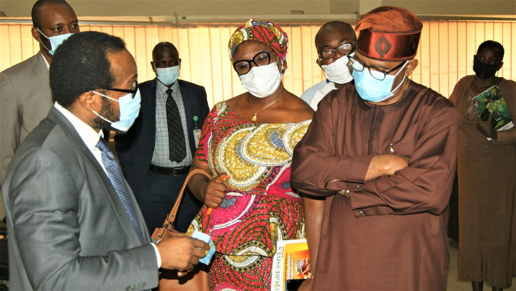 Dr Obi Adigwe updating the Hon Minister and his team on the Institute's innovative researches